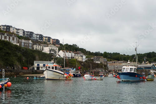 The outer harbour at Mevagissey, with many moored fishing boats: Cornwall, England, UK