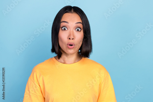 Portrait of positive gorgeous nice woman with bob hairdo dressed yellow t-shirt impressed staring isolated on blue color background
