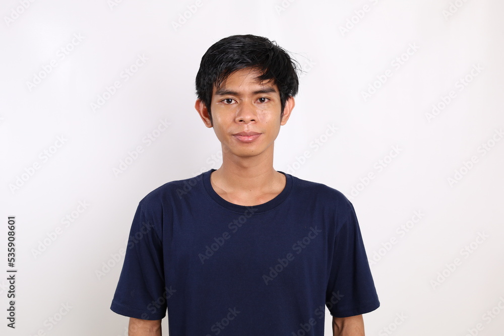 Asian young man standing while looking at the camera. Isolated on white background Asian young man standing while looking at the camera. Isolated on white background