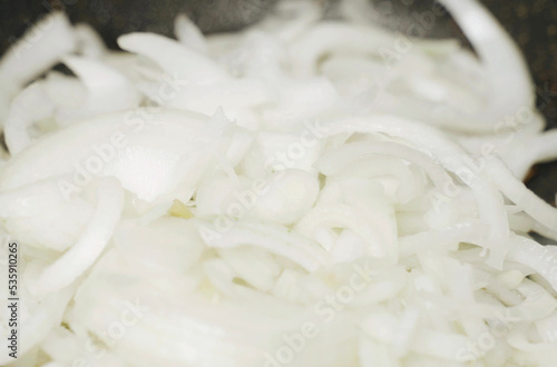 Chopped onions are fried in a pan in vegetable oil, stirring occasionally