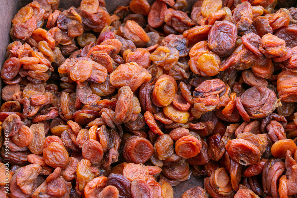 Dried apricot fruits forming a background. Dried apricots are dried pitted apricot halves. Dried apricot fruits forming a background. Dried apricots are dried pitted apricot halves.