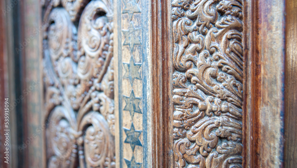 detail of a wooden door with wood carving 