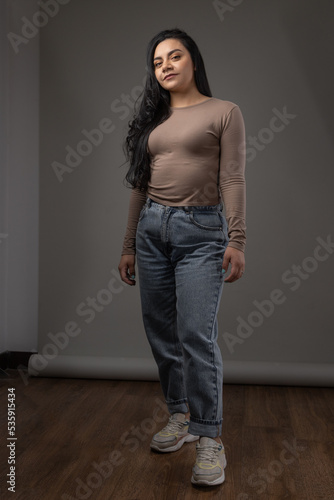 beauty details of latin woman wearing blouse with jeans in portrait, youth and casual fashion, person posing