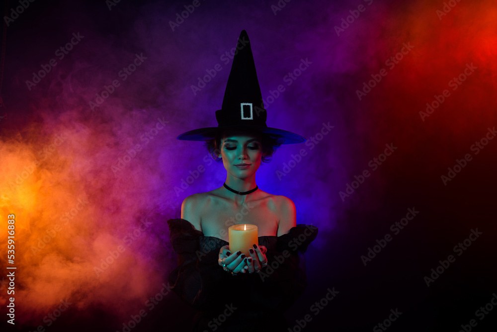 Photo of lady sorceress doing fear frightening occult spell hold candle fire flame isolated on colorful background