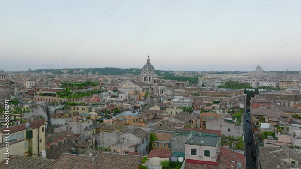 Aerial view of buildings in urban borough at dusk. Classic apartment buildings with rooftop terraces. Rome, Italy Aerial view of buildings in urban borough at dusk. Classic apartment buildings with rooftop terraces. Rome, Italy