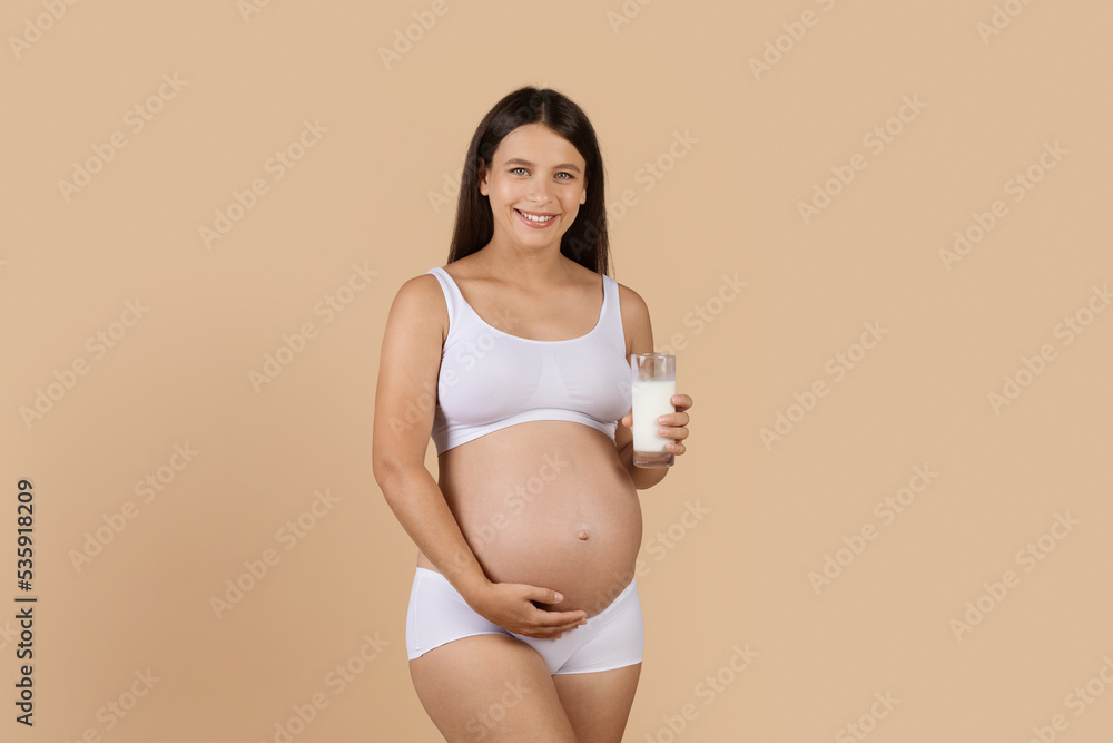 Healthy Drinks. Smiling Pregnant Woman In Underwear Holding Glass Of Milk Healthy Drinks. Smiling Pregnant Woman In Underwear Holding Glass Of Milk