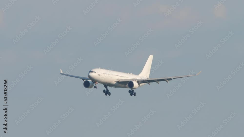 Widebody airliner landing gear release and descent at Sochi airport. Tourism and travel concept Widebody airliner landing gear release and descent at Sochi airport. Tourism and travel concept