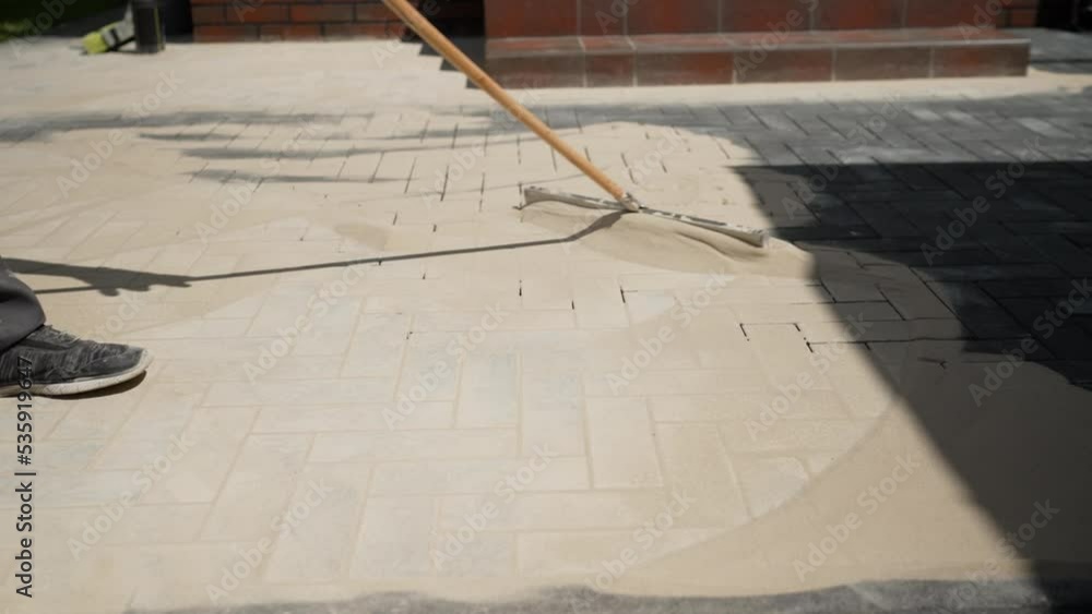 Laying paving slabs on the paths of the reconstructed park and filling