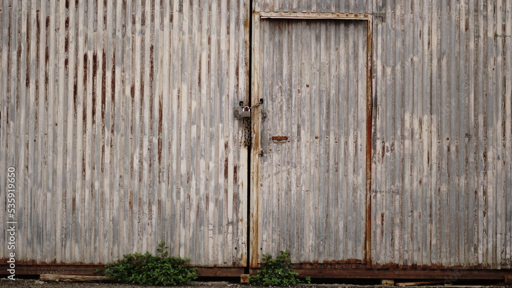 rusty industrial metal door of abandoned warehouse rusty industrial metal door of abandoned warehouse