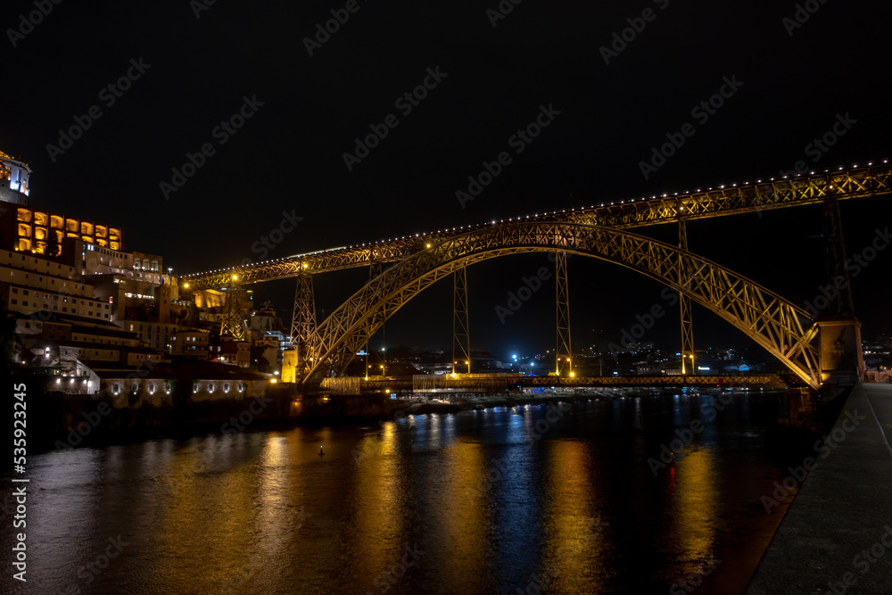 Night view of Dom Luis I bridge and the Douro River, in the city of Porto old town, Portugal.