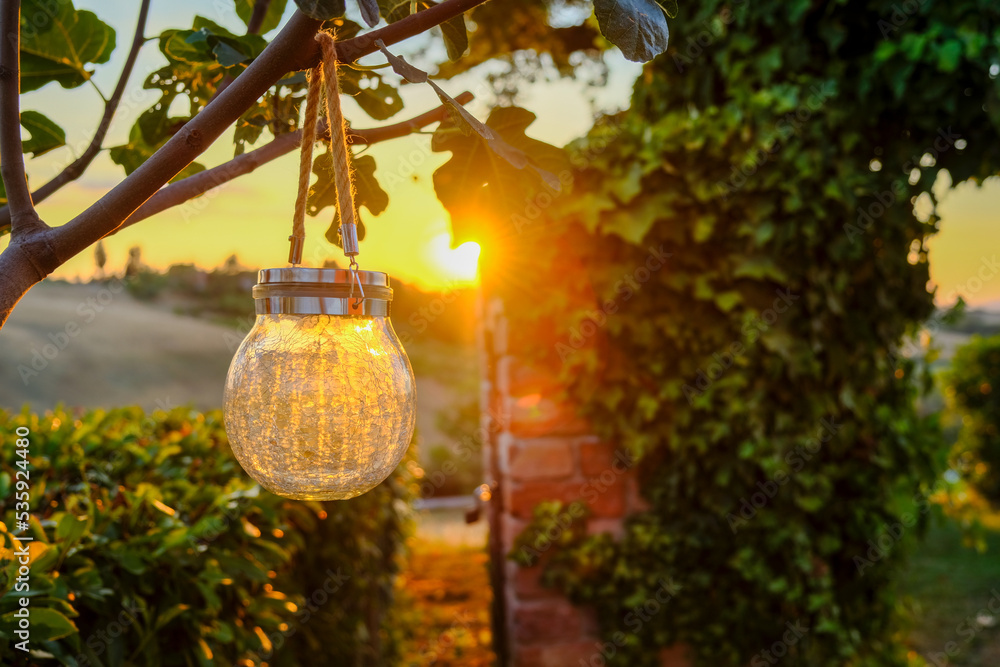 Suggestive solar-powered light, in the countryside, at sunset. Holidays in Tuscany.