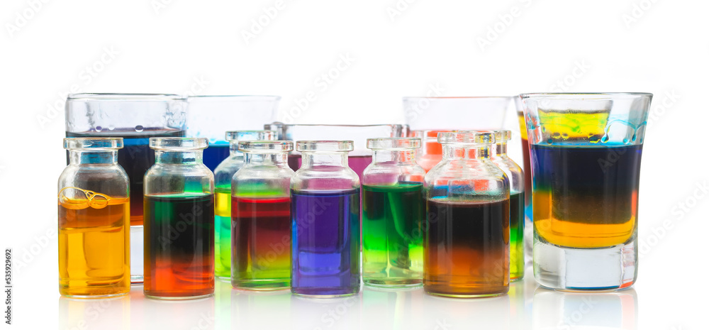 Colored water in mini glass bottles on white background Colored water in mini glass bottles on white background