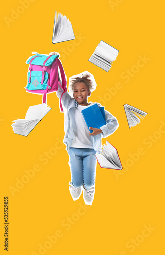 Jumping African-American schoolgirl with backpack and many books on yellow ba...