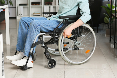 Young man with physical disability in office