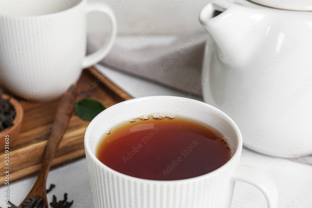 Cup of hot black tea on table, closeup Cup of hot black tea on table, closeup
