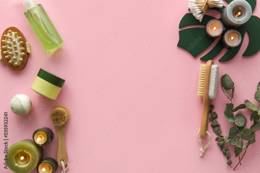 Composition with bath accessories, cosmetics and burning candles on pink background