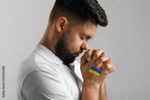 Young man with drawn flag o...