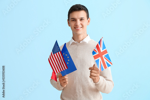 Teenage boy with flags of U...