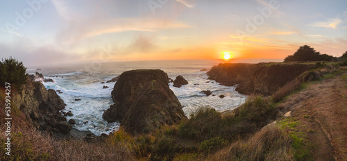 Waves crashing on rocks with sunset in Northern California 