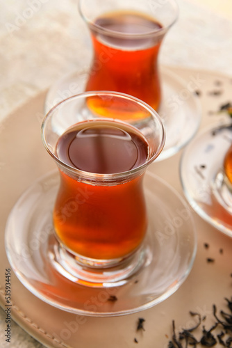 Glass cup with aromatic tea on table, closeup