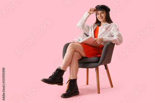 Stylish young woman reading...