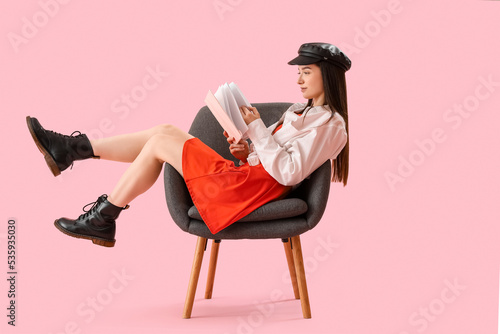 Stylish young woman reading...