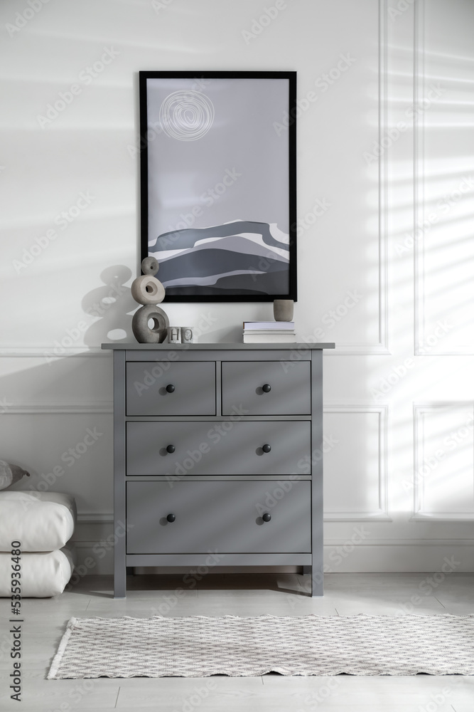 Stylish room interior with grey chest of drawers and beautiful picture Stylish room interior with grey chest of drawers and beautiful picture