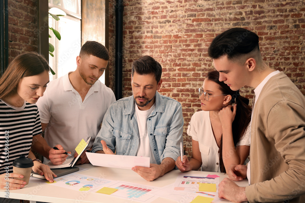 Team of employees working together in office Team of employees working together in office