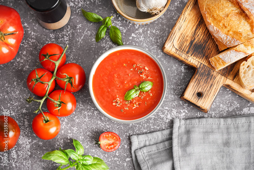 Obraz na plátně Bowl of delicious tomato soup on grunge background