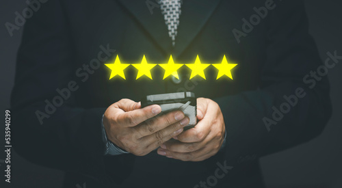 Service satisfaction rating concept. Business people using mobile phones give the highest rating of five stars. opinion poll answering the questionnaire Service Rating.