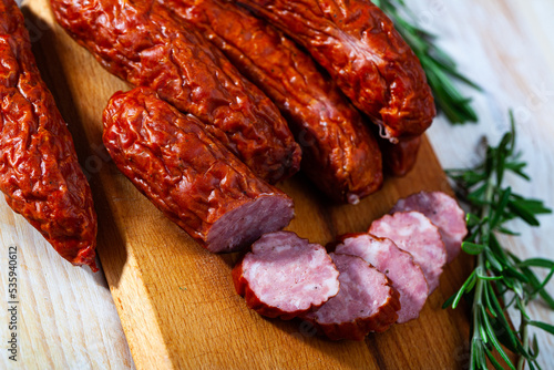 Roasted chezh sausages susena on cutting board. High quality photo