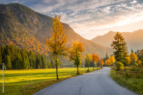 Country road in Alps at dramatic autumn sunrise, Karwendel mountains, Tyrol
