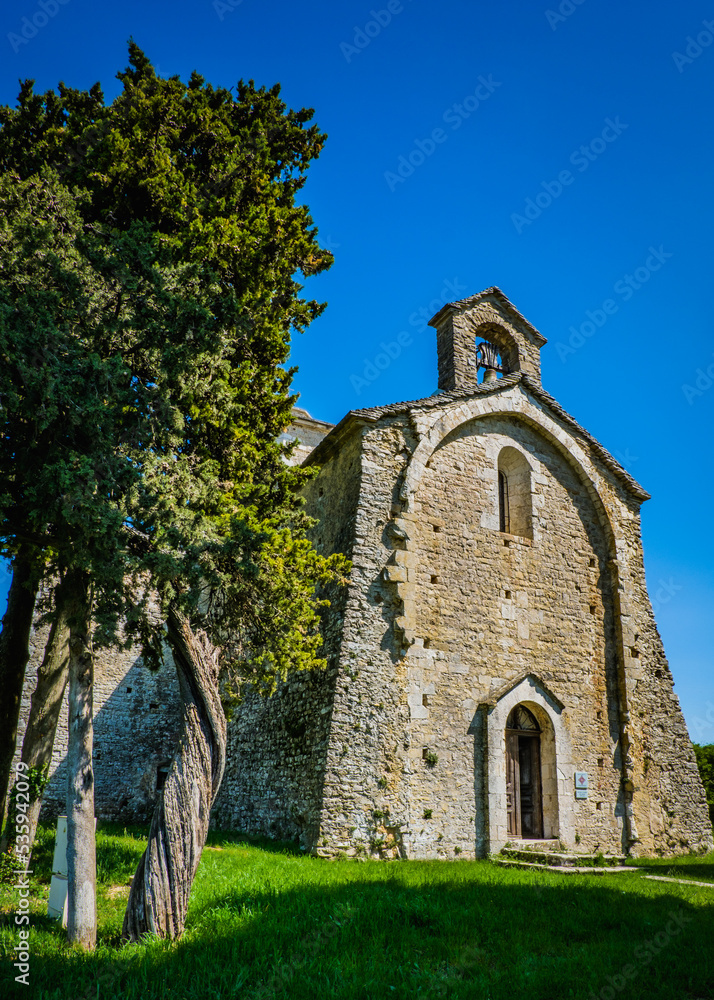 View on the small romanesque church of Saint Pierre de Larnas in the South of France (Ardeche)