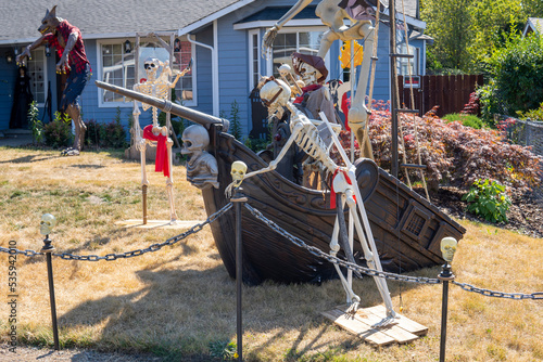 House yard decorated for Halloween with skulls, skeletons, werewolf, pirate ship