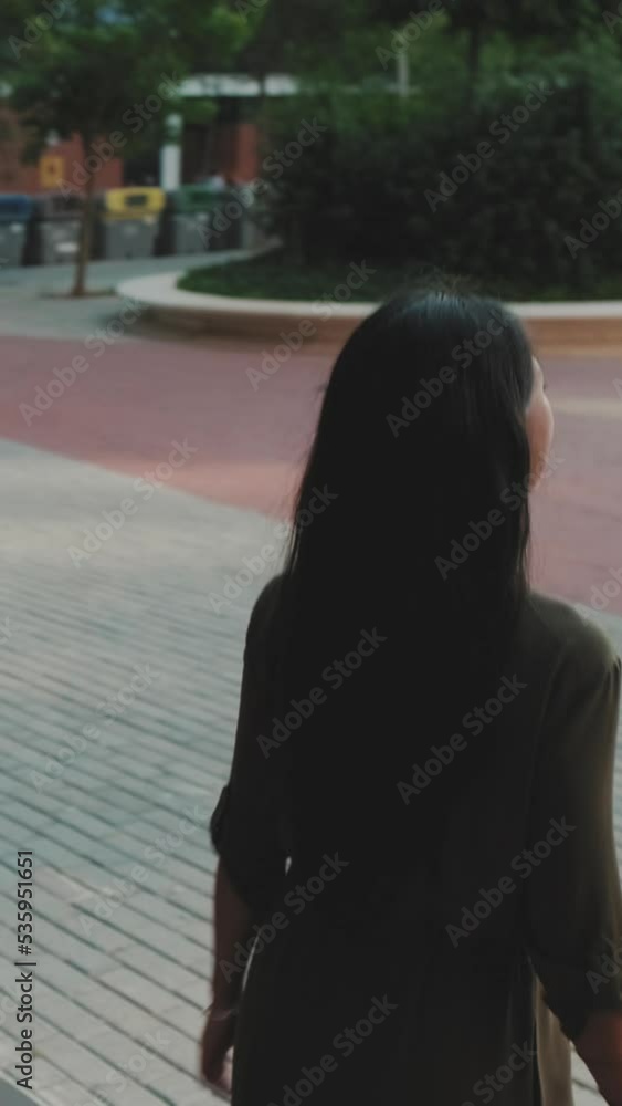 VERTICAL VIDEO: Young businesswoman walking down the stairs of the business center VERTICAL VIDEO: Young businesswoman walking down the stairs of the business center