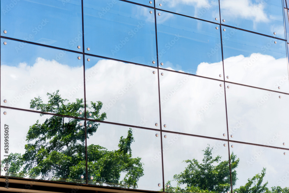 Clouds reflected in modern office building wall Clouds reflected in modern office building wall