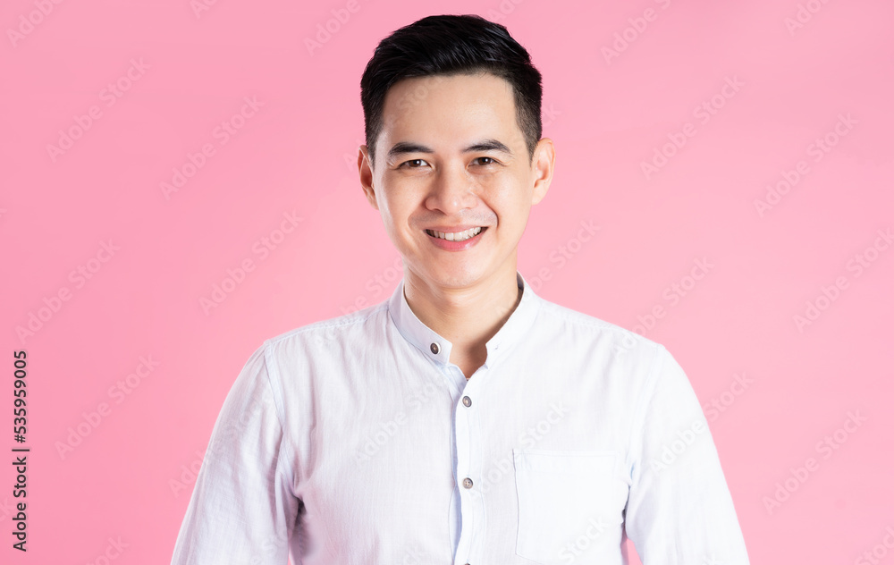 portrait of asian man posing on pink background portrait of asian man posing on pink background