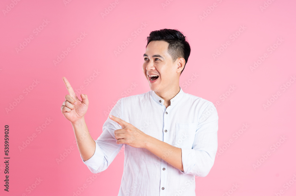 portrait of asian man posing on pink background portrait of asian man posing on pink background