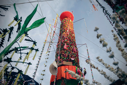 Salak yom at Wat Phra That Hariphunchai in Lamphun. The tradition of making merit, the tall dyed lott trees are decorated with different colored paper and clothing items to pay homage to the souls. photo