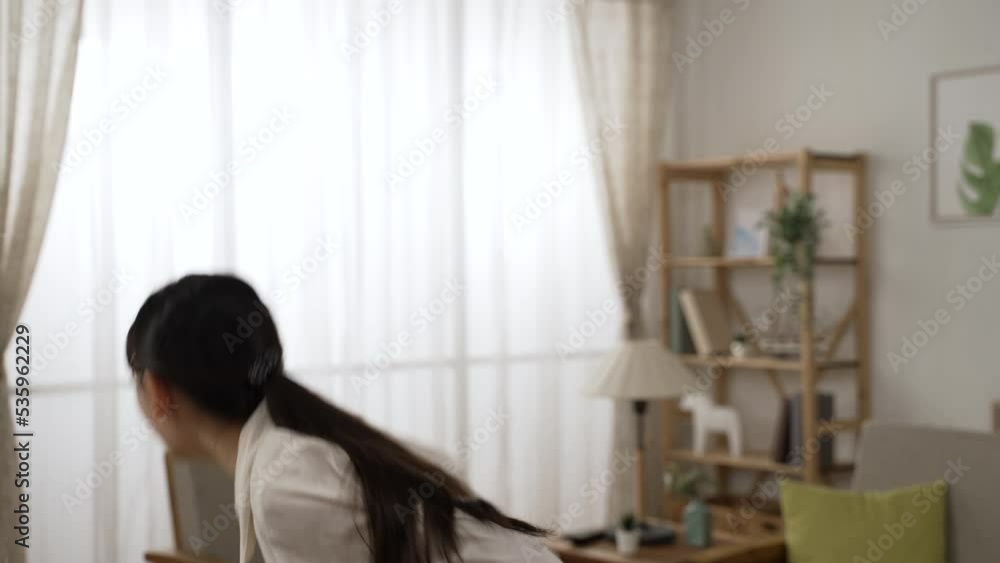 happy chinese female entrepreneur reading notification letter is shouting and jumping for joy since she’s excited about getting bank loan approval at home happy chinese female entrepreneur reading notification letter is shouting and jumping for joy since she’s excited about getting bank loan approval at home
