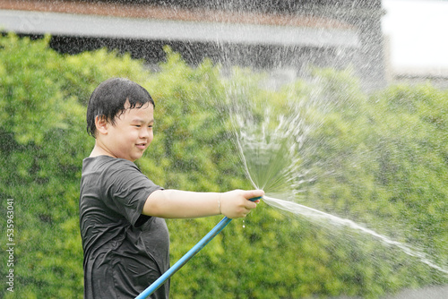boy play water with hose