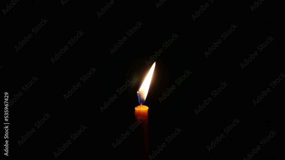 burning candle light up in the dark. burning candle light up in the dark.