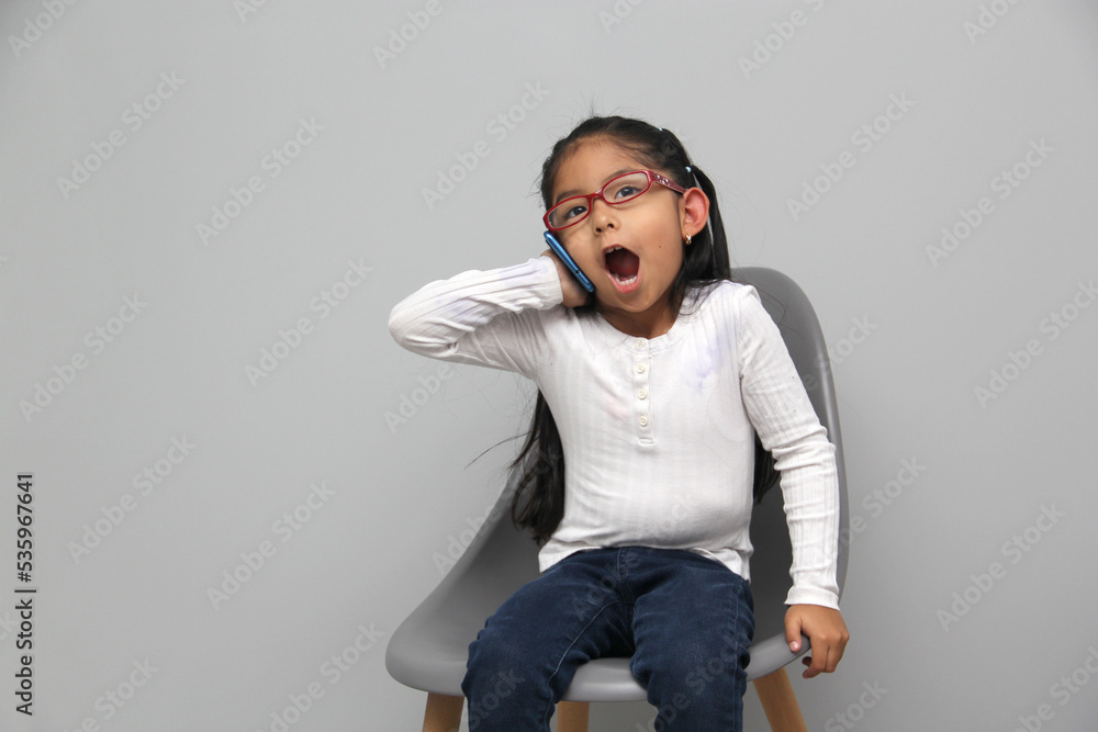 4-year-old latin girl uses her cell phone to make video calls, play video games, send messages, take photos, selfies, watch and record videos as an influencer and have fun in her free time 4-year-old latin girl uses her cell phone to make video calls, play video games, send messages, take photos, selfies, watch and record videos as an influencer and have fun in her free time