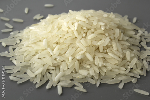 Close up of grains of white rice against a grey background