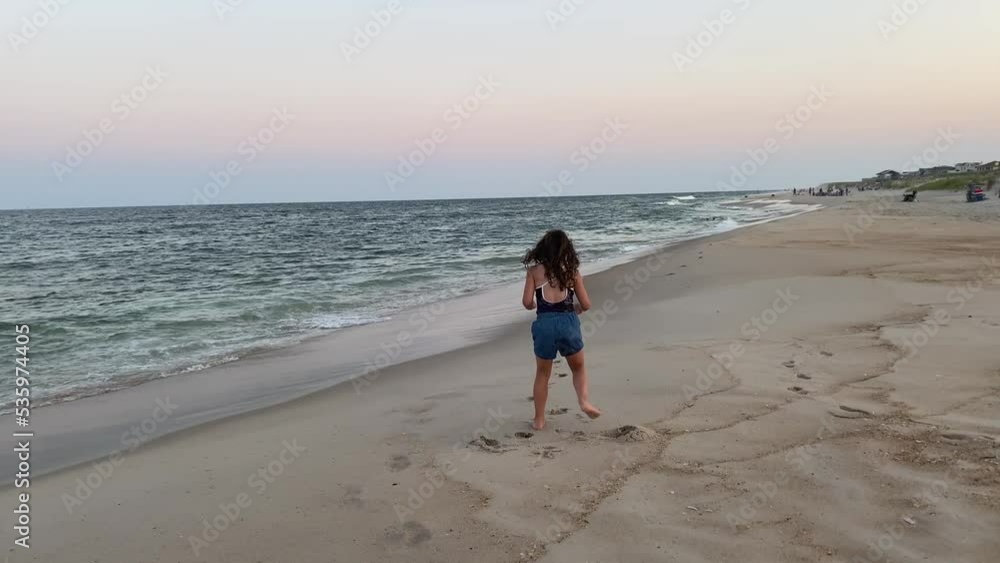 young girl having fun on a beach shoreline young girl having fun on a beach shoreline