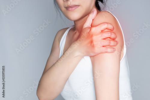 Asian woman is rubbing arm with pain syndrome and feel numb and cramp photo