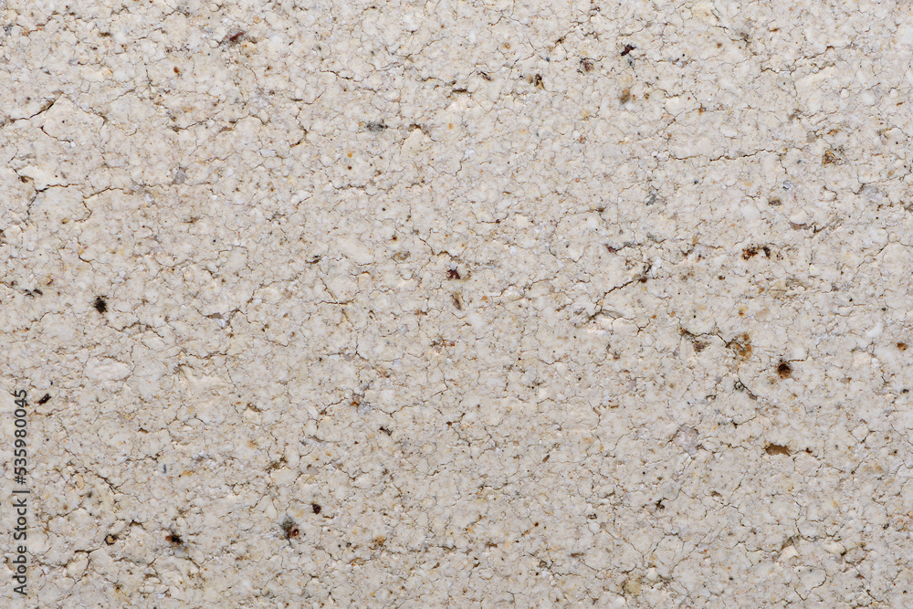 Extreme close-up section of a white house brick showing speckles cracks coarse surface Extreme close-up section of a white house brick showing speckles cracks coarse surface
