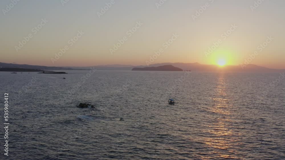 Aerial - Fishing boat in Chania, Greece at sunset from high Aerial - Fishing boat in Chania, Greece at sunset from high