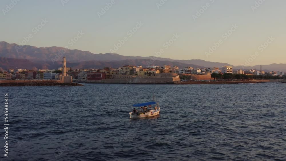 Aerial - Small fishing boat floating in Chania, Greece Aerial - Small fishing boat floating in Chania, Greece