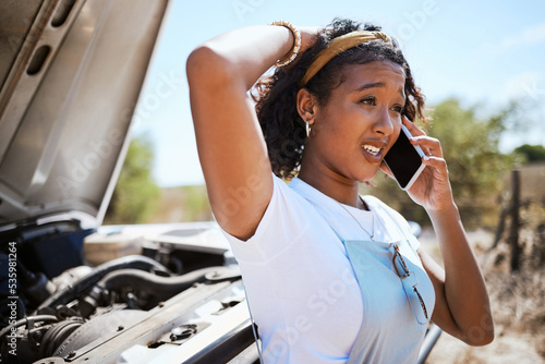 Car, woman and phone call for help and roadside assistance while driving in a stress, stress and anxiety from vehicle trouble. Driver, travel and accident by black woman worried and concerned in road photo